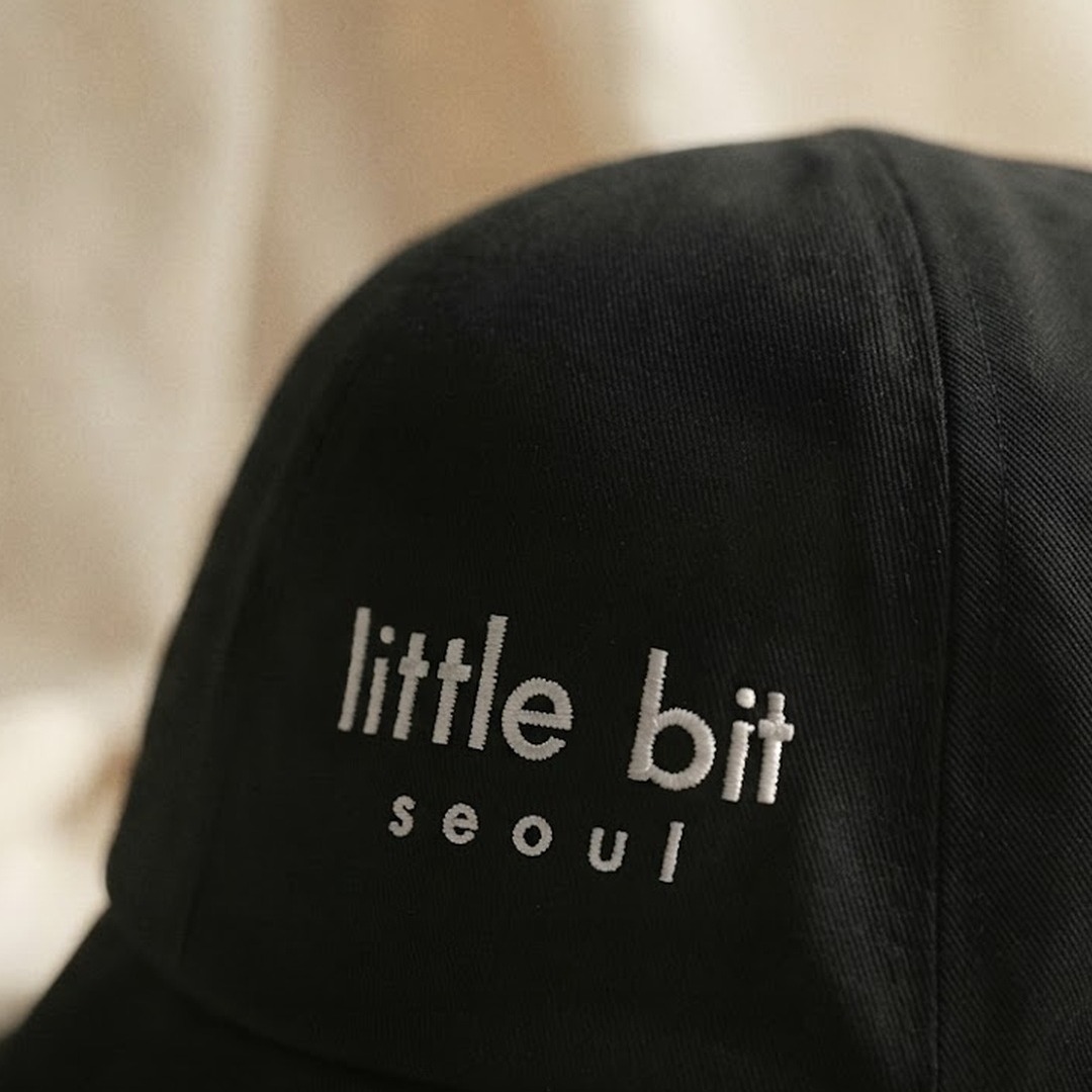 little bit seoul bucket hat — embroidered wordmark detail, close up